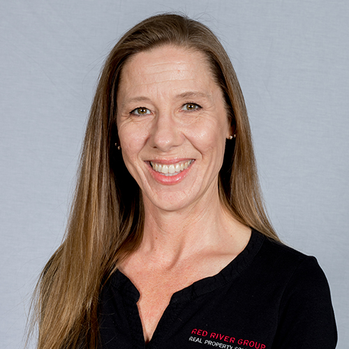 A smiling woman in a black shirt.